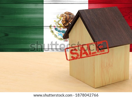 The concept sale of apartments, of real estate mortgages, citizenship and accommodation, as well as investment in a future home. Mexico flag on wooden background.