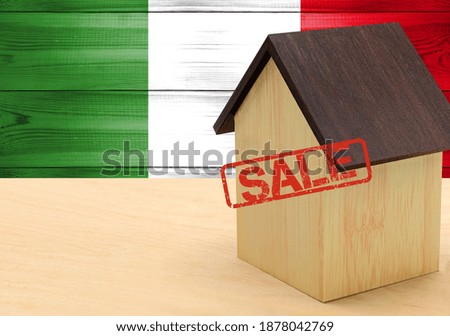 The concept sale of apartments, of real estate mortgages, citizenship and accommodation, as well as investment in a future home. Italy flag on wooden background.
