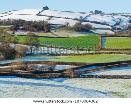 Snow on colourful green and white Shropshire Hills, near Clun, in December for Christmas. Beautiful hilly British landscape, England, UK, stock photo