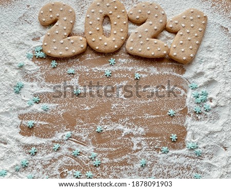2021 new year with copy space. Christmas gingerbreads date 2021 on flour background 