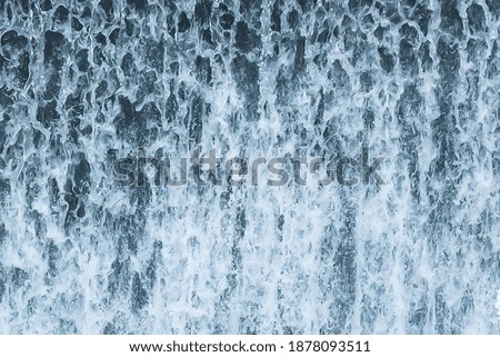 Small waterfall from river close-up in natural basin