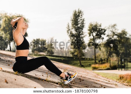 Side view photo of slim caucasian girl resting after fitness outdoors