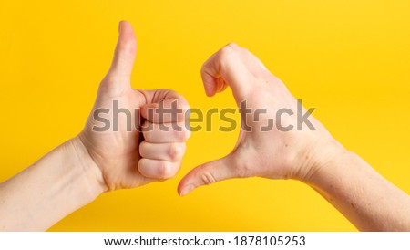 Friendzone hand sign on yellow background. Friend zone symbol. Friendzoned hands shape Royalty-Free Stock Photo #1878105253