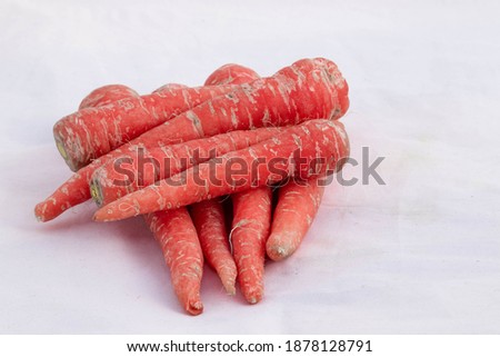 Red And Orange Organic Indian Breed Carrots Are Recommended By Doctors Which Helps Boost Heart Health Immunity In Weight Loss And Glow Skin. Isolated On White Background With Space For Custom Text