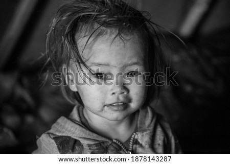 The extreme north, Yamal, life of Nenets people, the dwelling of the peoples of the north, a girl playing in a yurt in the tundra, unhappy childhood, black and white photo