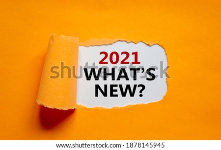 2021 what is new symbol. The words '2021 what is new' appearing behind torn orange paper. Business and 2021 what is new concept. Copy space.