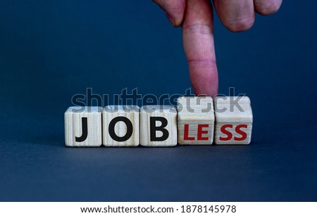 Jobless or job symbol. Male hand flips wooden cubes and changes the word 'jobless' to 'job'. Beautiful grey background, copy space. Business and jobless or job concept.