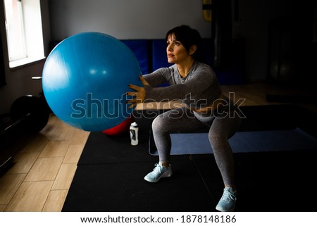 Beautiful young athletic woman working out at the gym
