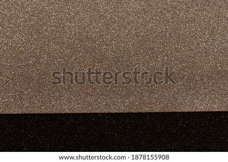 Bronze and black bokeh abstract light background. Festive Christmas design element. Shimmer