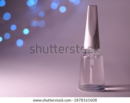 Colorless nail polish. A bottle with clear nail polish on white background. Nail lacquer. Royalty-Free Stock Photo #1878161608