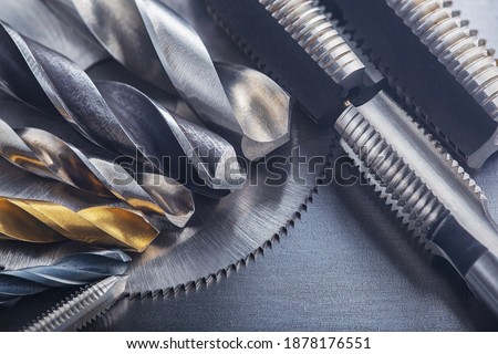 set of different drill bits,thread tap and mill cutters on steel plate background. Locksmithing deal. Royalty-Free Stock Photo #1878176551