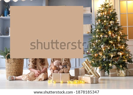 background, space for yor text. girl and Christmas glowing garland. A little girl is stay on the floor. Girl holding a garland with glowing stars in her hands. Image with selective focus.