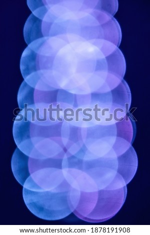 Abstract pink and blue blurred lights resembling a large polymer molecule