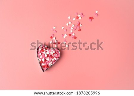 Heart in the shape of a flying comet on a pink background. Top view with space to copy. Concept of February 14, love.