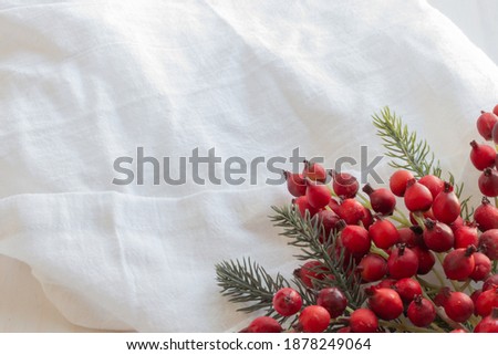 Christmas berries on white linen