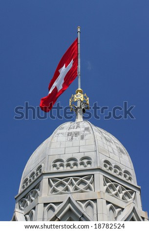 Swiss flag on top of the Grossmunster tower, Zurich, Switzerland
