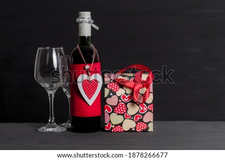Wine Bottle, Shopping bag, white box and red Heart of Valentine's Day on the black background