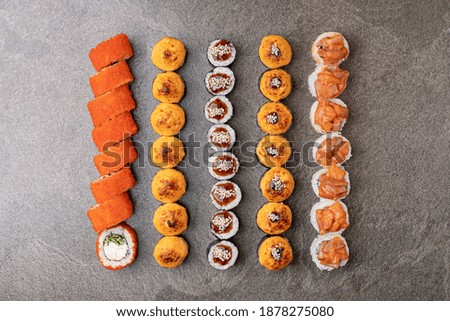 
set of sushi lying on shiny stone surface