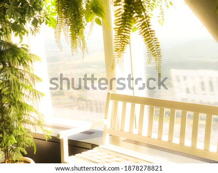 White bench with leaves in a dreamy and fantastic background