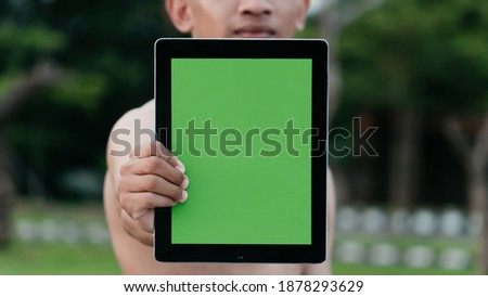Close up sportsman holding the tablet. Display the copy space on the tablet
