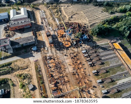 Large pile of scrap metal, gantry crane. Aerial view.