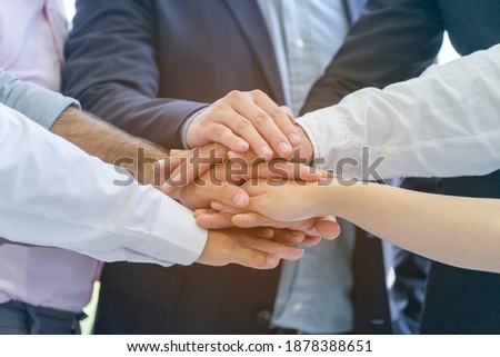 Group of business people making strong handshake after vision and mission completed. Teamwork collaboration which sharing goal, objective together to support organization unity and business successful Royalty-Free Stock Photo #1878388651