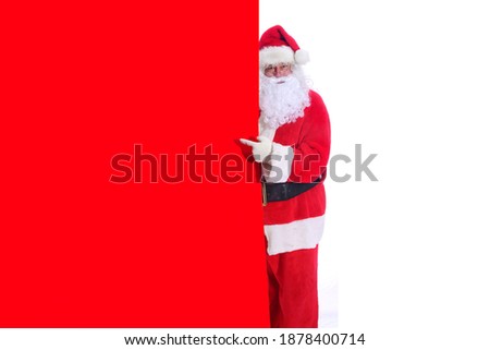 Santa Claus Points to a Giant Red Sign. Santa holds a Giant Red Sign while Isolated on White. Room for Text or Images. Christmas Sign. Holiday Advertising.
