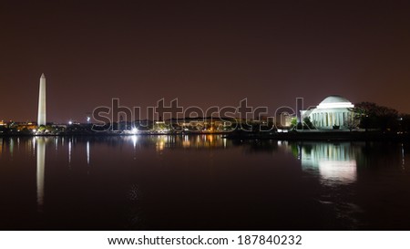 Washington Monument and Jefferson Memorial at night with city skyline on background. Colorful reflections of Washington landmarks in Tidal Basin.