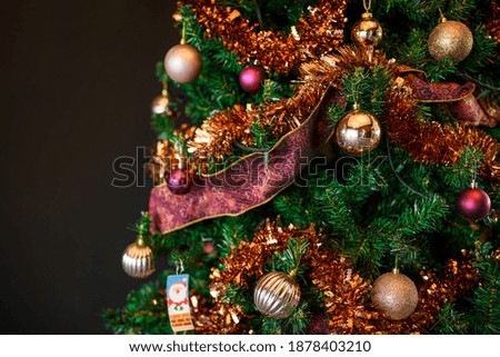 Decorated beautiful Christmas tree on blurred dark background