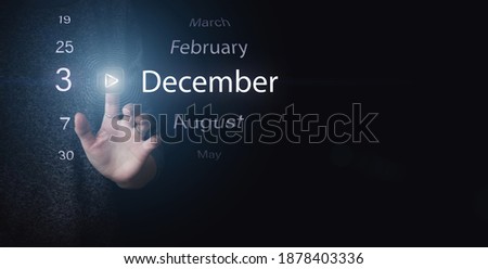 December 3rd. Day 3 of month, Calendar date. Hand click luminous icon PLAY and DATE on dark blue background. Winter month, day of the year concept