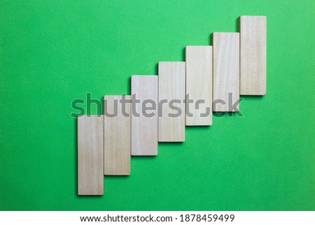 A ascending graphic with pieces of wood and green background. to fill with words or drawings. copy for space. space for text and drawings