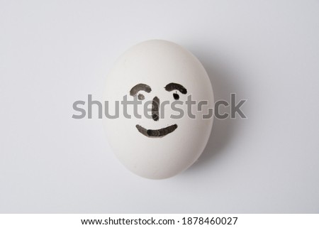 Egg with a happy and joyful person on a white background copy space.