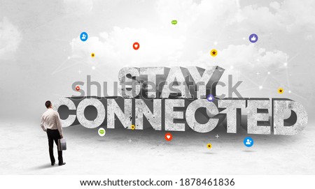 Young businessman standing in front of STAY CONNECTED inscription, social media concept