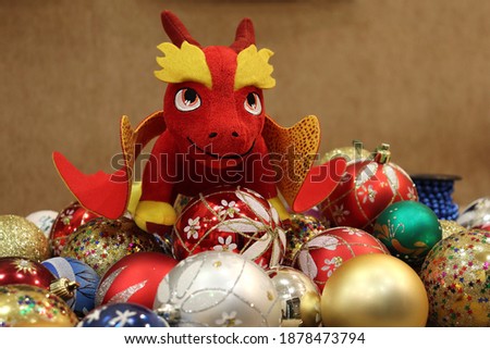 Christmas toy balls and a red dragon in a festive mood