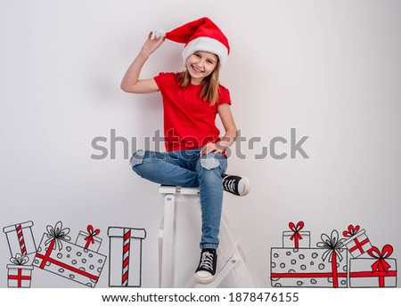 Smiling little girl beside christmas presents