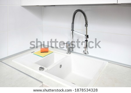 Upscale kitchen Ultimate Gray interior with Illuminating yellow sponge for washing dishes. Faucet mixer and stone sink with rinsing compartment and external controlled adjustable drain.