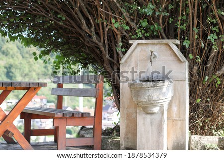 old water fountain, made in nature so that passers-by can rest and refresh themselves with drinking water
