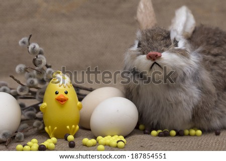 Happy Easter. Easter rabbit and chicken with a sprig of willow. Photo.