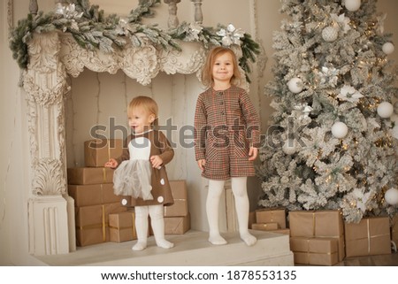Beautiful sisters on christmas decorated room 