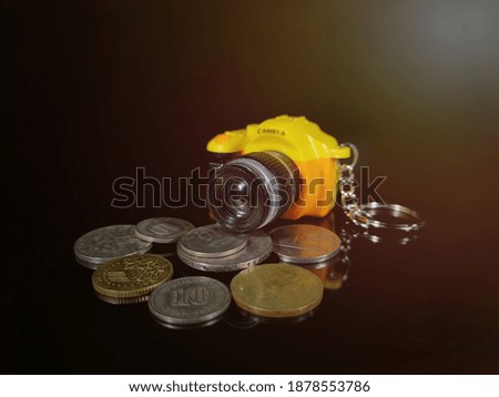 Picture of a Business Money Concept Idea,camera and coins with soft flare background.