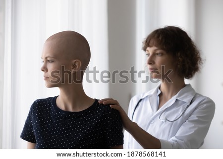 To find right words. Caring doctor comfort console sad depressed young female sick with cancer touch her shoulder from behind. Qualified medical specialist help upset patient to fight serious disease Royalty-Free Stock Photo #1878568141
