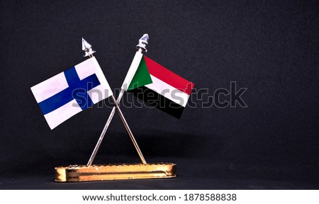 Finland and Sudan table flag with black Background