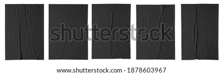 black paper wrinkled poster template , blank glued creased paper sheet mockup. black poster mockup on wall. empty paper mockup. clipping path Royalty-Free Stock Photo #1878603967