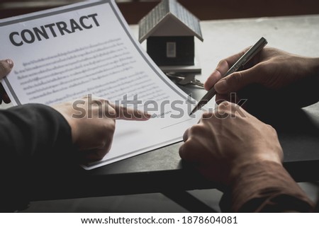 The seller and buyer are agreeing to sign a property purchase contract, man signing a contract, property lease ideas.