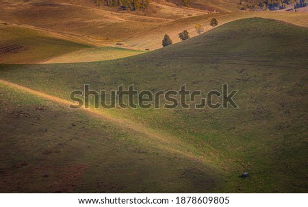 Picturesque Evening on Rolling Hills at Altai Krai, West Siberia, Russia. Calm Tranquil Atmosphere, Layered Slopes in Shadows and Light. Striped Undulating Unreal Abstract Steppe Terrain. 