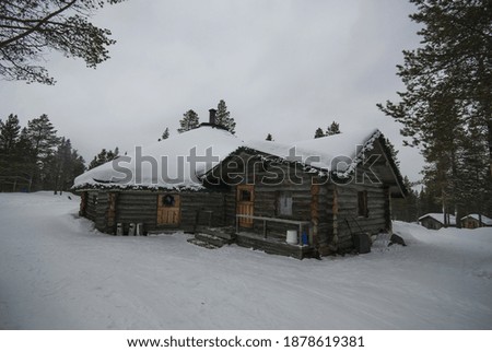 wooden chalet, snowy weather. Lapland, Finland. 