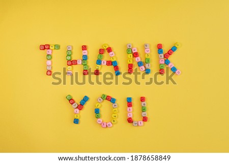 Thank you on bright yellow background. Words made of colourful bricks with number. International Thank You day.