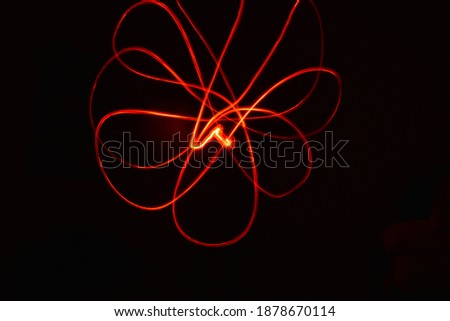 beautiful abstract theme of red light painting evil dark night streaks ray blowing art 