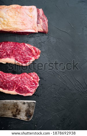 Striploin steak, raw beef butchery cut, on black background, top view, with copy space for text