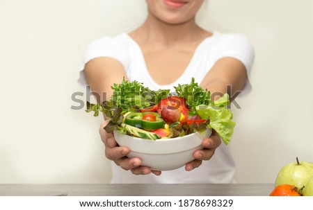 asian women with vegetable mix salad on hand for good heathy and dieting Royalty-Free Stock Photo #1878698329